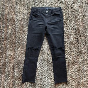 RtA black denim jeans with cuts at the knees